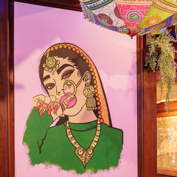 Indian-inspired pop art of a woman in traditional jewelry and henna, with a colorful umbrella.