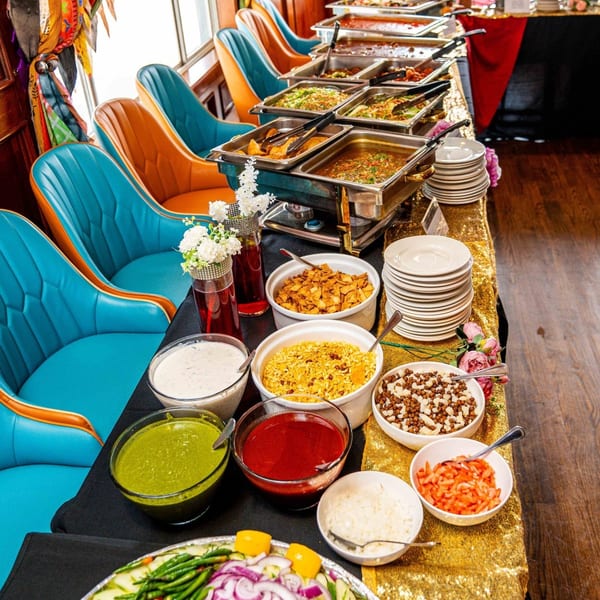 Indian buffet with various dishes, sauces, and sides, set on a gold sequin tablecloth.