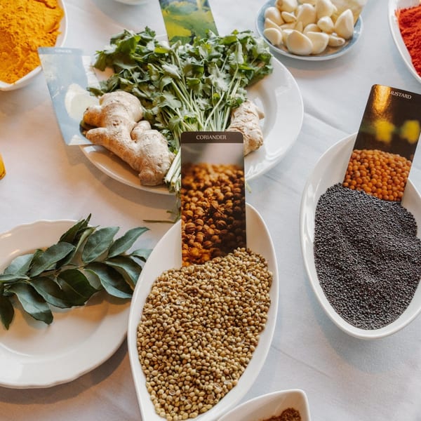 Indian spices and fresh ingredients, including ginger, coriander, curry leaves, and mustard seeds.